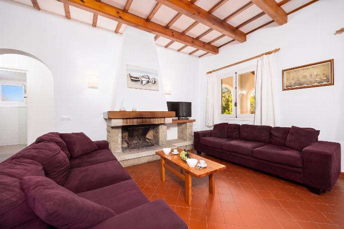 Living room with sofas, dining area, ornamental fireplace, WiFi internet, and satellite TV . - Villa Trepuco Dos . (Photo Gallery) }}