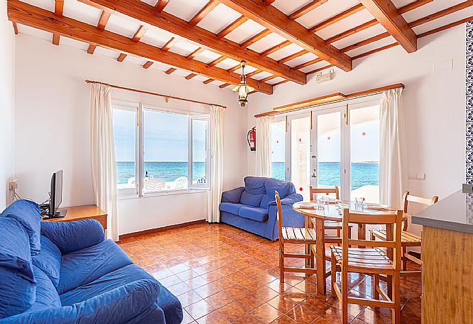 Open-plan living room with sofas, dining area, kitchen, WiFi internet, TV, and sea views . - Voramar Waterfront . (Photo Gallery) }}