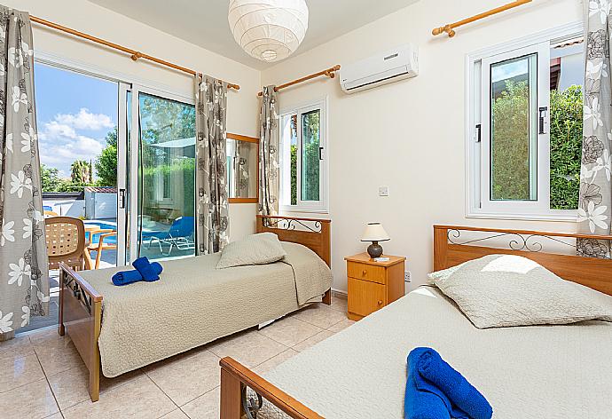 Twin bedroom with en suite bathroom, A/C, and terrace access . - Villa Zenon . (Photo Gallery) }}