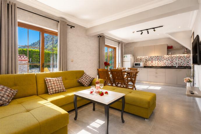 Open-plan living room with sofa, dining area, kitchen, A/C, WiFi internet, satellite TV, and terrace access . - Villa Canan Paradise . (Photo Gallery) }}