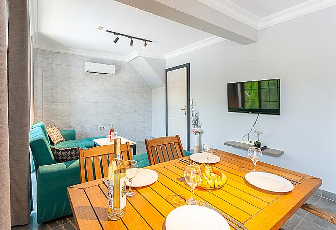 Open-plan living room with sofas, dining area, kitchen, A/C, WiFi internet, satellite TV, and terrace access . - Villa Deniz Paradise . (Photo Gallery) }}