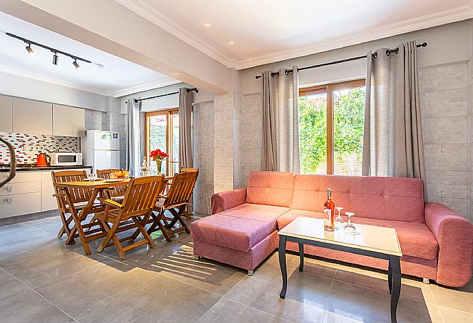 Open-plan living room with sofa, dining area, kitchen, A/C, WiFi internet, satellite TV, and terrace access . - Villa Elmas Paradise . (Photo Gallery) }}