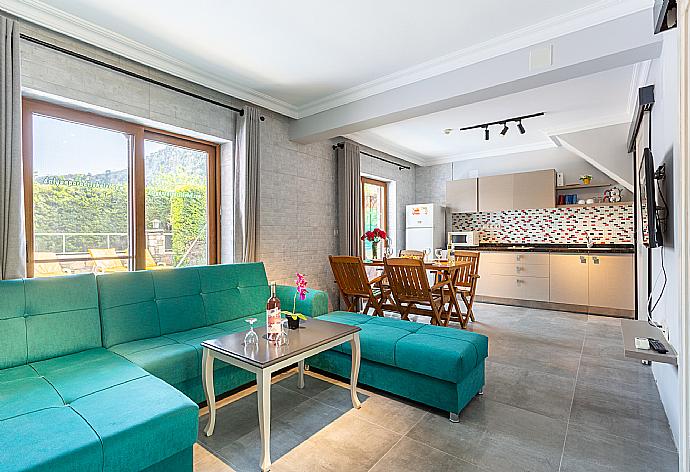 Open-plan living room with sofa, dining area, kitchen, A/C, WiFi internet, satellite TV, and terrace access . - Villa Ayla Paradise . (Галерея фотографий) }}