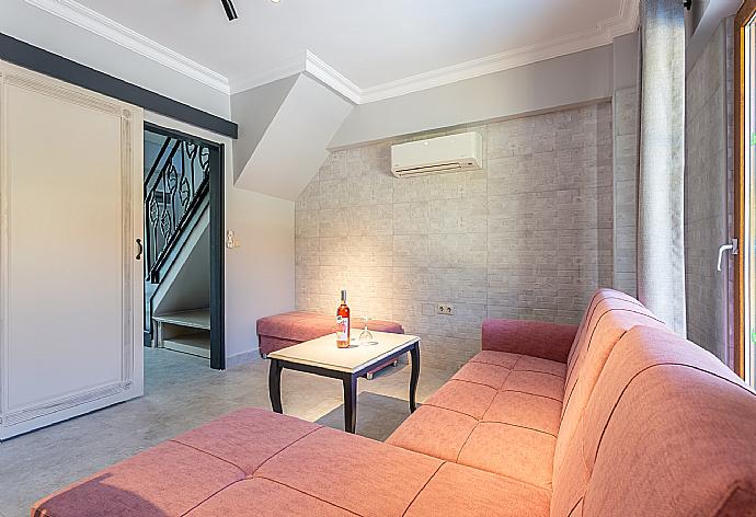 Open-plan living room with sofa, dining area, kitchen, A/C, WiFi internet, satellite TV, and terrace access . - Villa Melek Paradise . (Галерея фотографий) }}