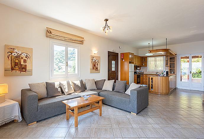 Open-plan living room with sofa, dining area, kitchen, WiFi internet, and balcony access with sea views . - Villa Vasso . (Photo Gallery) }}