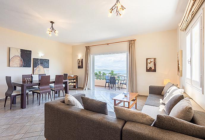 Open-plan living room with sofa, dining area, kitchen, WiFi internet, and balcony access with sea views . - Villa Vasso . (Photo Gallery) }}