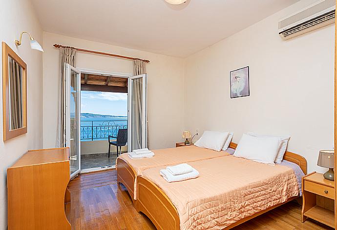 Twin bedroom with A/C and balcony access with panoramic sea views . - Villa Vasso . (Photo Gallery) }}