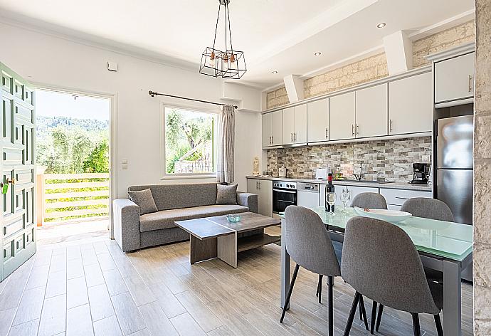 Open-plan living room with sofa, dining area, kitchen, WiFi internet, and terrace access . - Villa Vasso . (Photo Gallery) }}