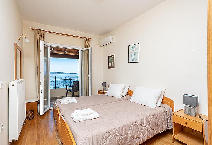 Twin bedroom with A/C and balcony access with panoramic sea views . - Villa Vasso . (Photo Gallery) }}
