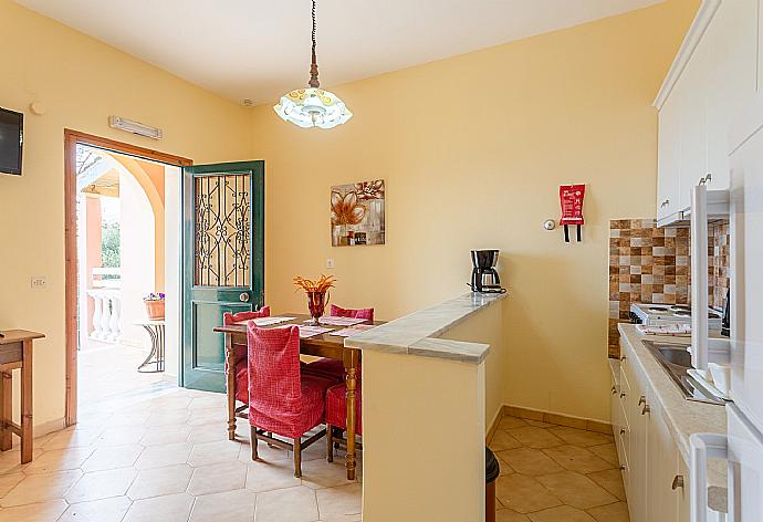 Living area with dining area, TV, kitchen, and terrace access . - Villa Thespina . (Galerie de photos) }}