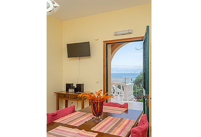 Living area with dining area, TV, kitchen, and terrace access . - Villa Thespina . (Γκαλερί Φωτογραφιών) }}
