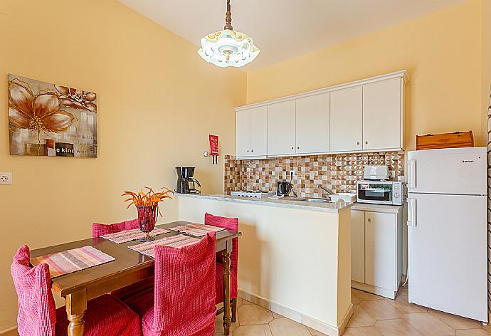 Living area with dining area, TV, kitchen, and terrace access . - Villa Thespina . (Galleria fotografica) }}