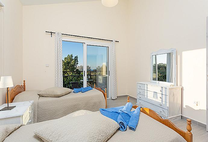 Twin bedroom with en suite bathroom, A/C, and balcony with sea views . - Sun Beach Villa Tria . (Photo Gallery) }}