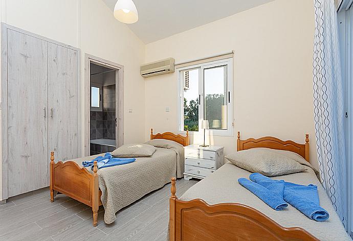 Twin bedroom with en suite bathroom, A/C, and balcony with sea views . - Sun Beach Villa Tria . (Photo Gallery) }}