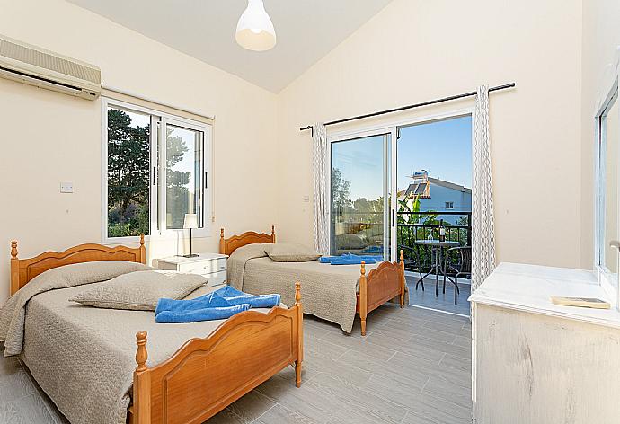 Twin bedroom with en suite bathroom, A/C, and balcony with sea views . - Sun Beach Villa Tria . (Photo Gallery) }}