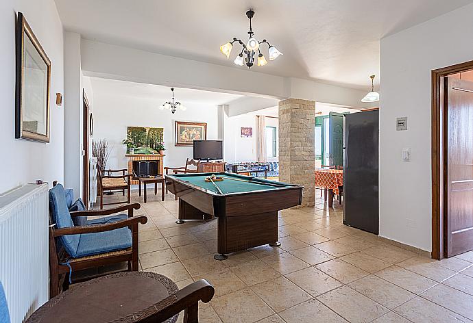 Second living room with sofas, dining area, kitchen, pool table, table football, ornamental fireplace, WiFi internet, satellite TV, and terrace access . - Villa Zeus . (Photo Gallery) }}