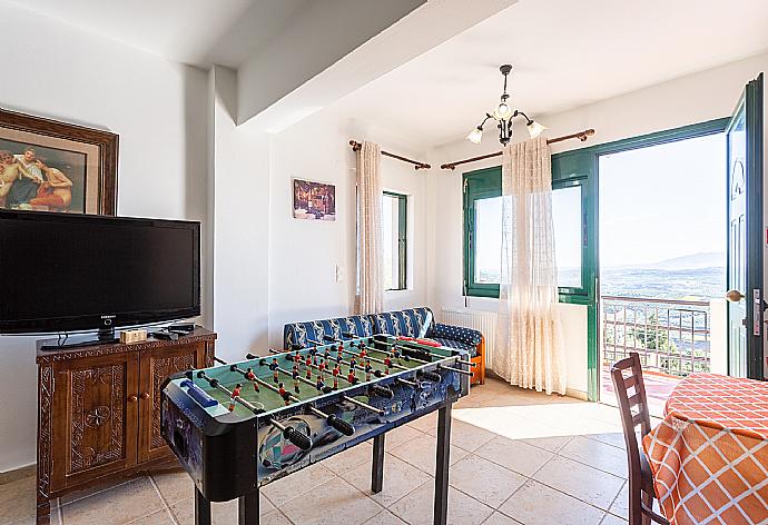 Second living room with sofas, dining area, kitchen, pool table, table football, ornamental fireplace, WiFi internet, satellite TV, and terrace access . - Villa Zeus . (Galería de imágenes) }}