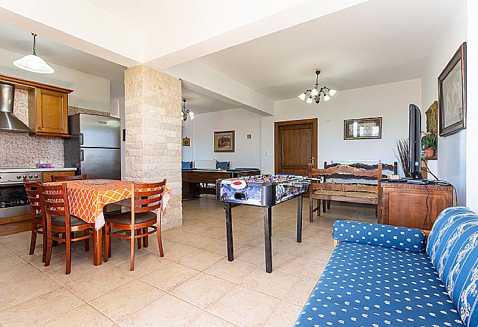 Second living room with sofas, dining area, kitchen, pool table, table football, ornamental fireplace, WiFi internet, satellite TV, and terrace access . - Villa Zeus . (Galería de imágenes) }}