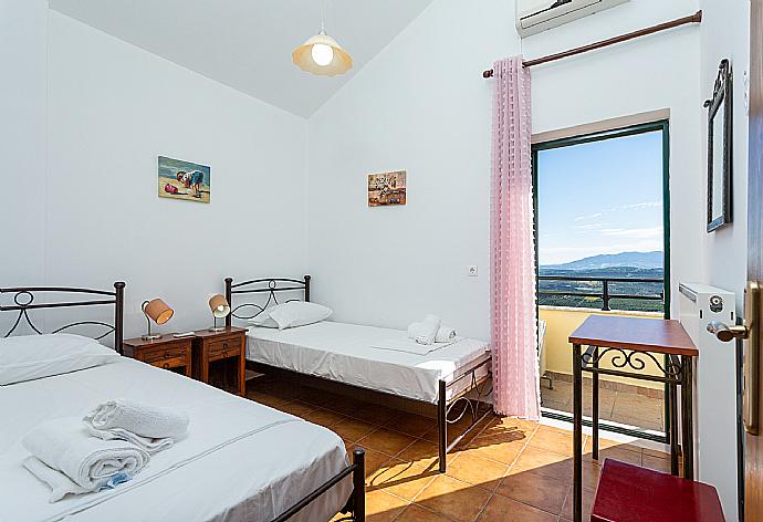 Twin bedroom with A/C and balcony access . - Villa Zeus . (Photo Gallery) }}