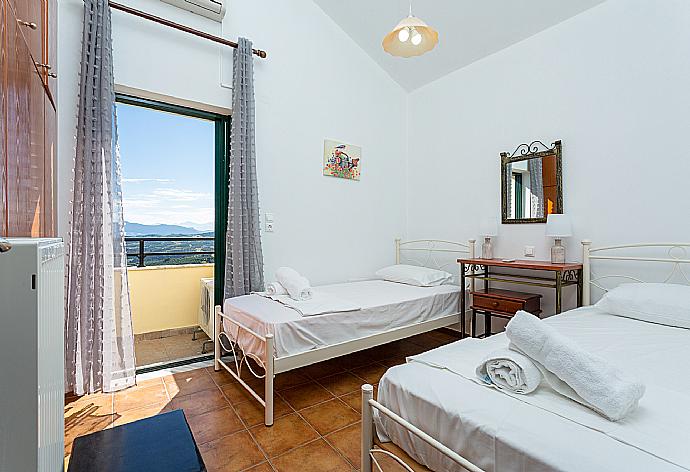 Twin bedroom with A/C and balcony access . - Villa Zeus . (Photo Gallery) }}