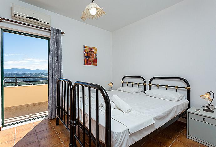 Twin bedroom with A/C and balcony access . - Villa Zeus . (Photo Gallery) }}