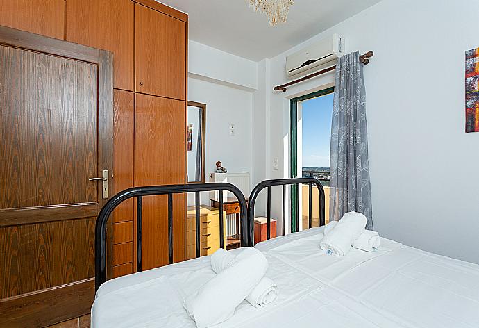 Twin bedroom with A/C and balcony access . - Villa Zeus . (Photo Gallery) }}