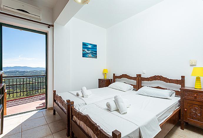 Twin bedroom with A/C and terrace access . - Villa Zeus . (Photo Gallery) }}