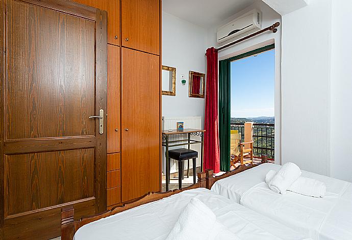 Twin bedroom with A/C and terrace access . - Villa Zeus . (Photo Gallery) }}