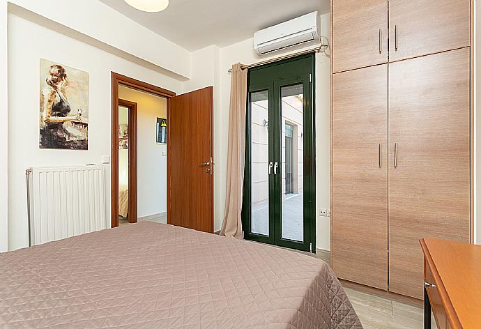 Double bedroom with A/C and balcony access . - Villa Olive . (Photo Gallery) }}