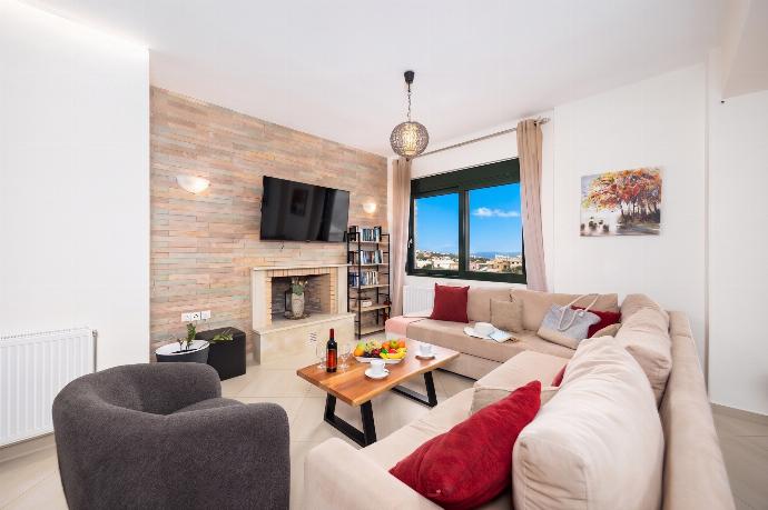 Open-plan living room with sofa, dining area, kitchen, ornamental fireplace, WiFi internet, and satellite TV . - Villa Olive . (Photo Gallery) }}