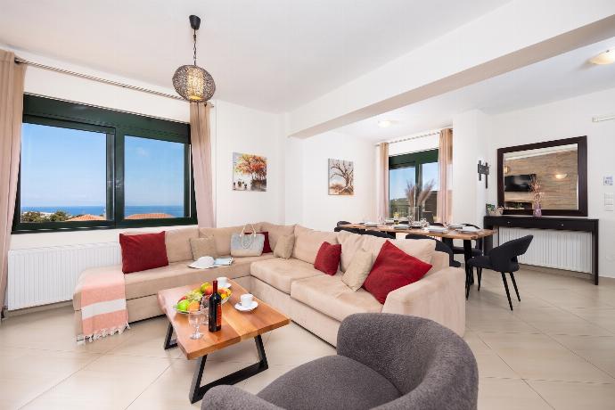 Open-plan living room with sofa, dining area, kitchen, ornamental fireplace, WiFi internet, and satellite TV . - Villa Olive . (Photo Gallery) }}