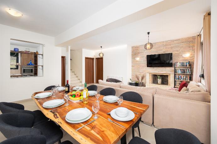 Open-plan living room with sofa, dining area, kitchen, ornamental fireplace, WiFi internet, and satellite TV . - Villa Olive . (Photo Gallery) }}