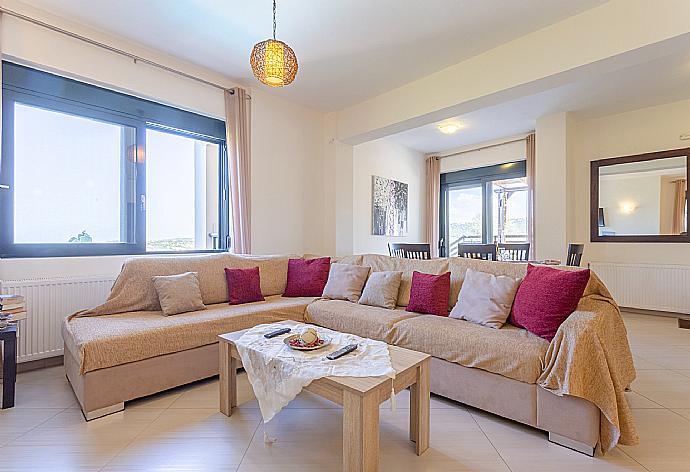 Open-plan living room with sofas, dining area, kitchen, ornamental fireplace, WiFi internet, satellite TV, and terrace access . - Villa Gerani Panorama . (Галерея фотографий) }}