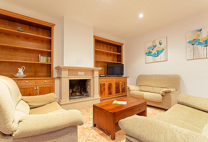 Living room with sofas, dining area, ornamental fireplace, WiFi internet, TV, DVD player, and pool terrace access . - Villa Biniparrell . (Fotogalerie) }}