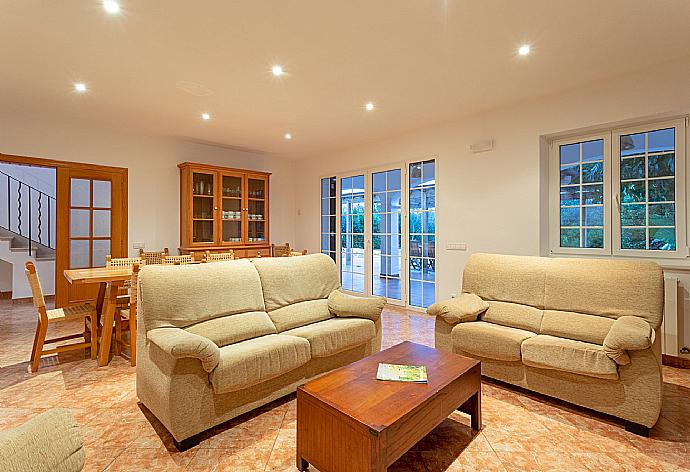 Living room with sofas, dining area, ornamental fireplace, WiFi internet, TV, DVD player, and pool terrace access . - Villa Biniparrell . (Галерея фотографий) }}