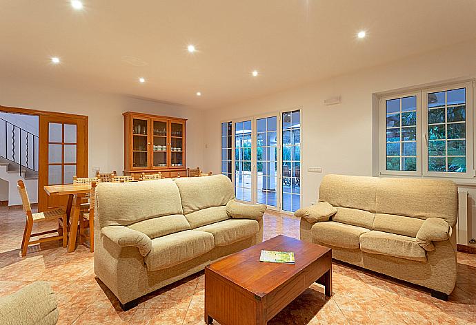 Living room with sofas, dining area, ornamental fireplace, WiFi internet, TV, DVD player, and pool terrace access . - Villa Biniparrell . (Galleria fotografica) }}