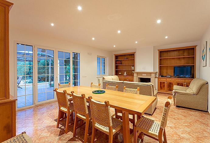 Living room with sofas, dining area, ornamental fireplace, WiFi internet, TV, DVD player, and pool terrace access . - Villa Biniparrell . (Fotogalerie) }}