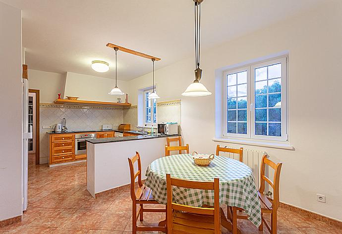 Dining area and equipped kitchen . - Villa Biniparrell . (Photo Gallery) }}