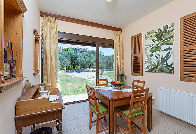 Open-plan living room with dining area, kitchen, A/C, WiFi internet, satellite TV, DVD player, and pool terrace access . - Villa Eufrosini . (Fotogalerie) }}