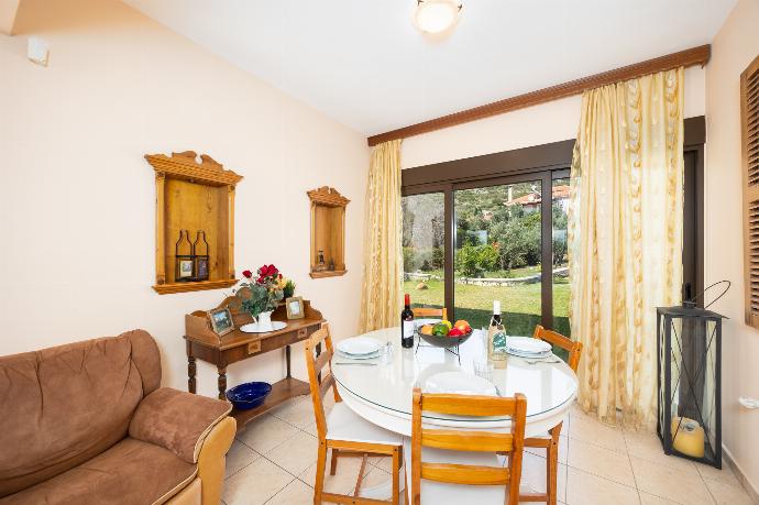 Open-plan living room with sofa, dining areas, kitchen, ornamental fireplace, A/C, WiFi internet, A/C, and satellite TV . - Villa Eufrosini . (Photo Gallery) }}
