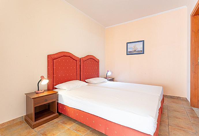 Twin bedroom on ground floor with en suite bathroom and A/C . - Villa Pelagos . (Photo Gallery) }}