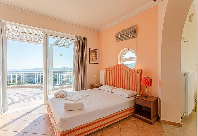 Double bedroom on second floor with en suite bathroom, A/C, and balcony access . - Villa Pelagos . (Photo Gallery) }}