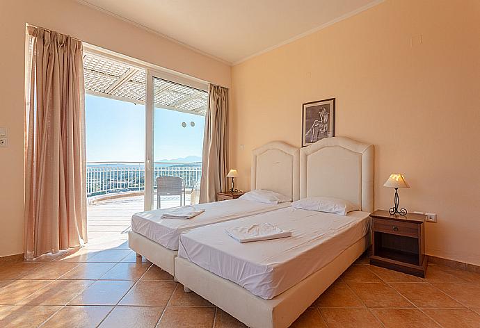 Twin bedroom on second floor with en suite bathroom, A/C, and balcony access . - Villa Pelagos . (Photo Gallery) }}