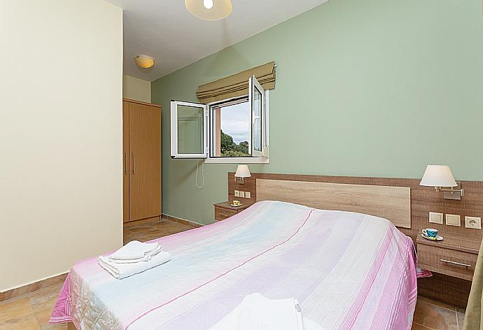 Double bedroom with en suite bathroom, A/C, and balcony access . - Villa Olympia . (Photo Gallery) }}