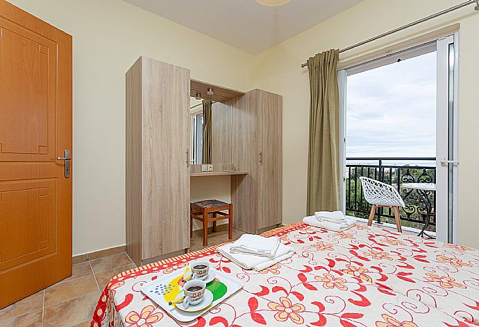 Twin bedroom with en suite bathroom, A/C, and balcony access . - Villa Olympia . (Photo Gallery) }}
