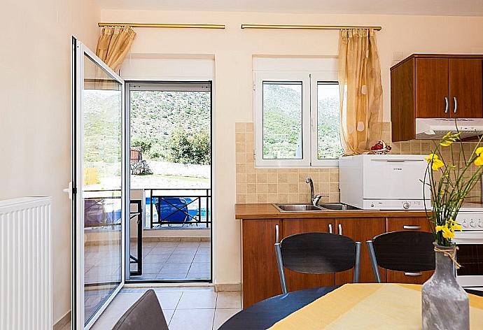 Equipped kitchen with dining area and terrace access . - Villa Nikolas Bali . (Photo Gallery) }}