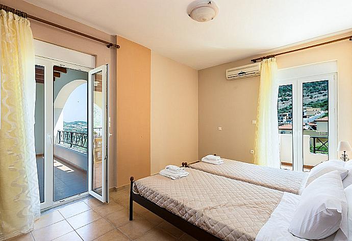 Twin bedroom with A/C and balcony access . - Villa Kostis . (Photo Gallery) }}