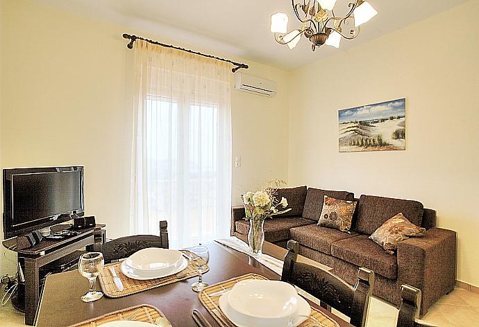 Living and dining area with WiFi, TV, DVD Player and terrace access . - Villa Kostis . (Photo Gallery) }}