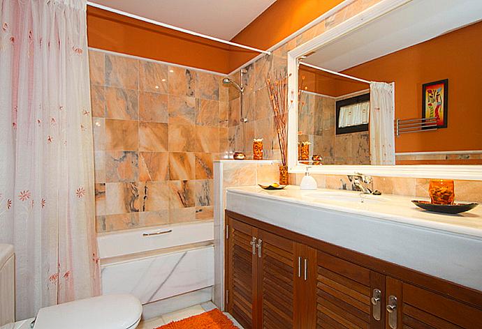 Bathroom with bath and overhead shower . - Villa Calma . (Photo Gallery) }}