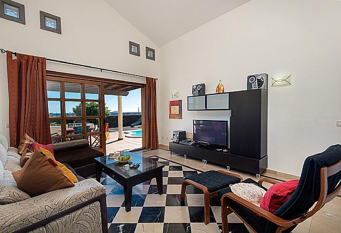 Living area with WiFi, TV, DVD player with terrace access . - Villa Calma . (Photo Gallery) }}